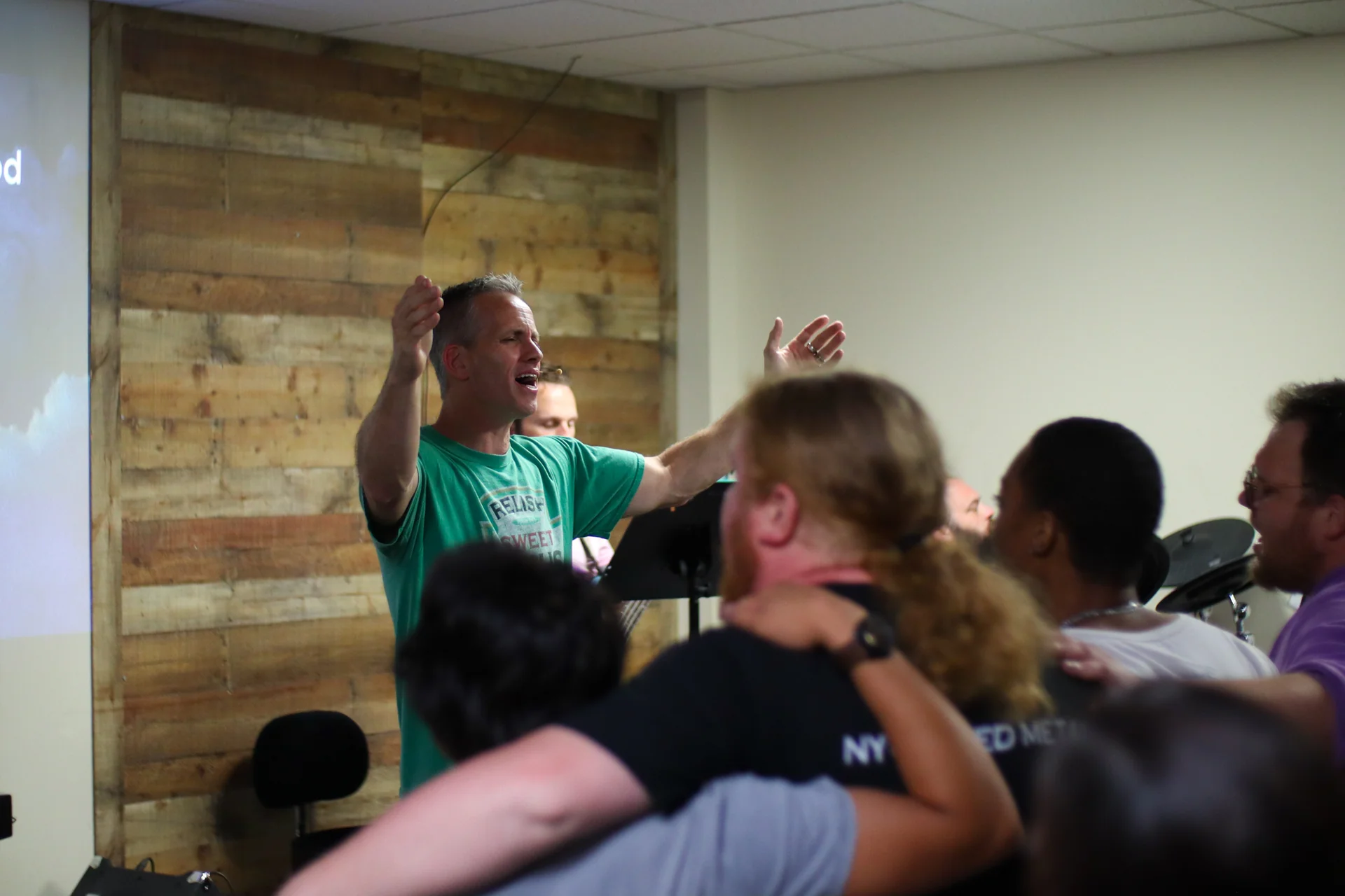 Pastor Jim Lowenstein leading worship at Matheteuo Ministries